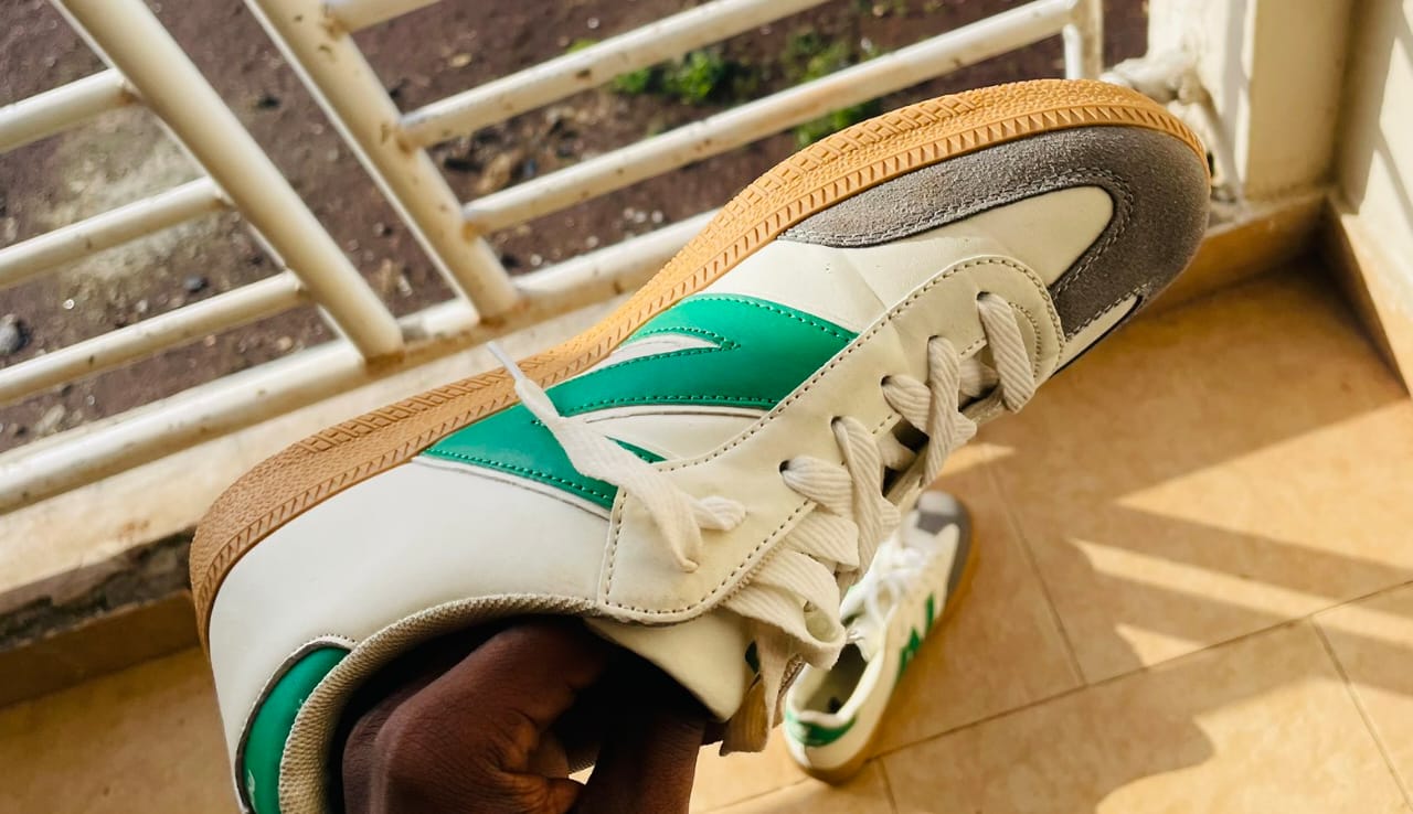 A white and green smooth newbalance sneaker